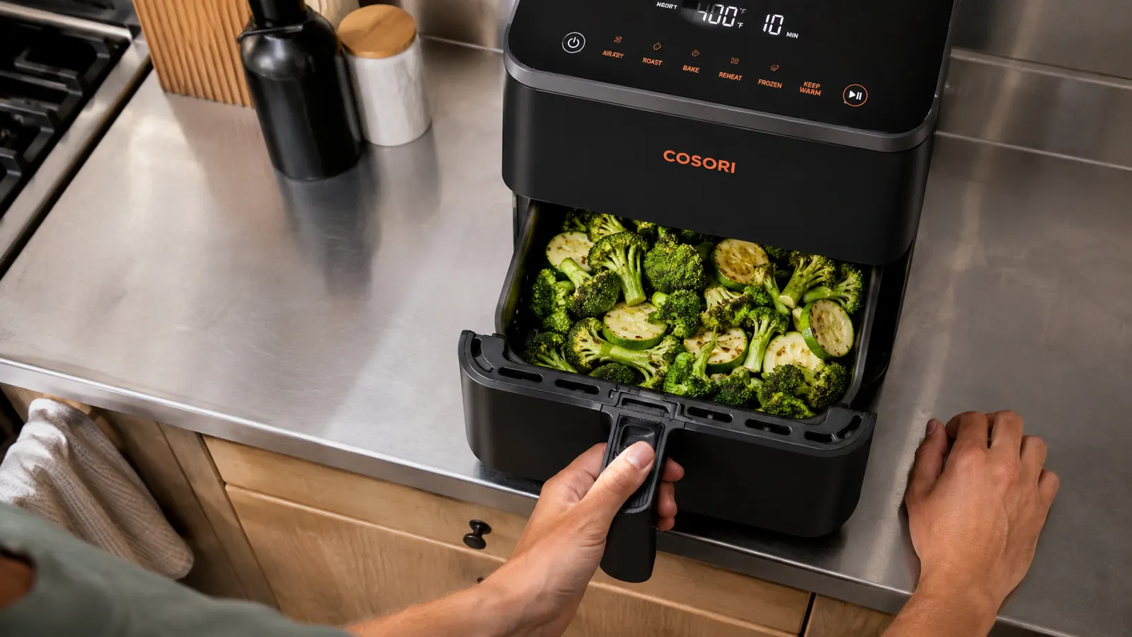 Cosori Pro LE air fryer basket being pulled out to show capacity with vegetables inside